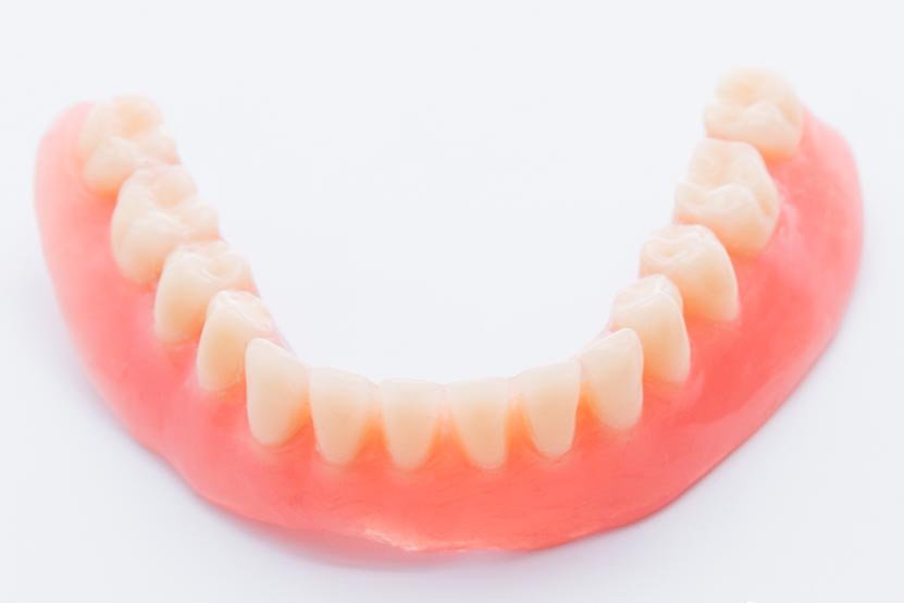 Set of dentures on white background